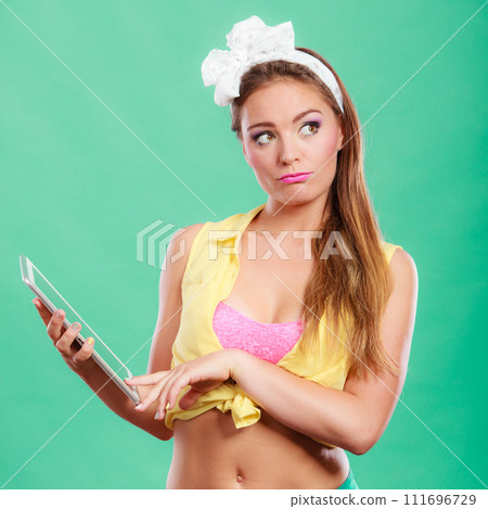 Pensive pin up fashion girl with pc tablet. 111696729