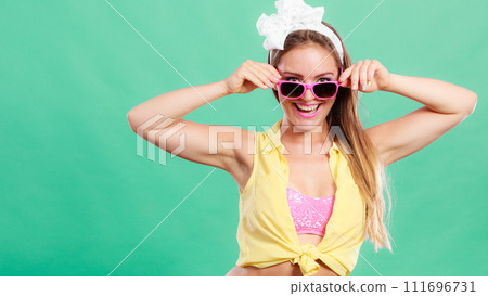 Portrait of happy pin up girl wearing sunglasses. 111696731