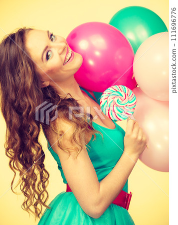 Woman with colorful balloons and lollipop 111696776
