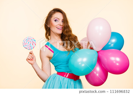 Woman with colorful balloons and lollipop 111696832