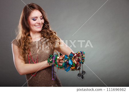 Pretty woman with jewelry necklaces beads and hat. 111696982
