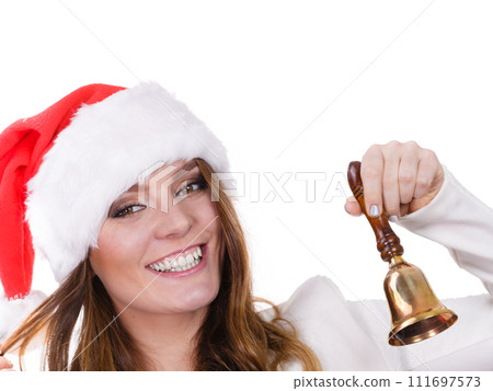 Woman in santa claus hat ringing a bell 111697573