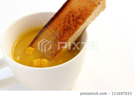 Corn soup with grains in a cup and toast Corn soup with grains in a cup and toast 111697833