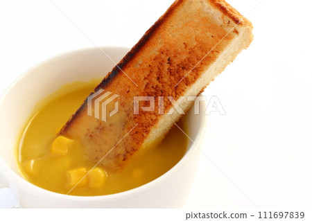 Corn soup with grains in a cup and toast Corn soup with grains in a cup and toast 111697839