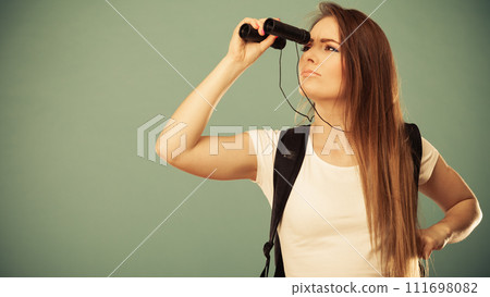 Tourist woman looking through binocular Tourist woman looking through binocular 111698082