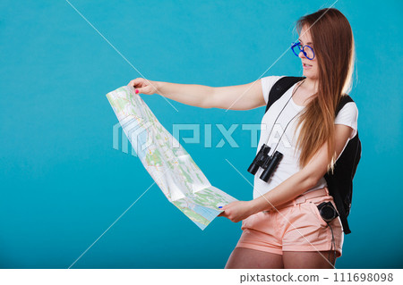 Tourist woman sunglasses read map on blue 111698098