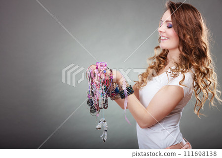 Pretty woman with jewelry necklaces ring bracelets 111698138