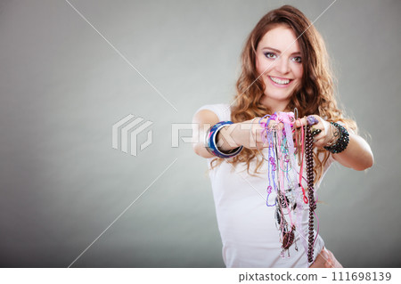 Happy woman with jewelry necklaces ring bracelets 111698139