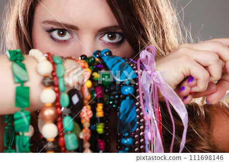Pretty woman with jewelry necklaces bracelets 111698146