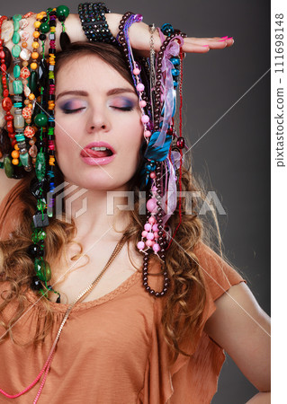 Pretty woman with jewelry necklaces bracelets 111698148