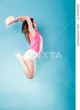 Summer woman in straw hat jumping Summer woman in straw hat jumping 111698481