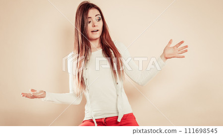Worried woman with spread hands. 111698545