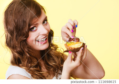 Closeup woman eating fruit cake sweet food 111698615