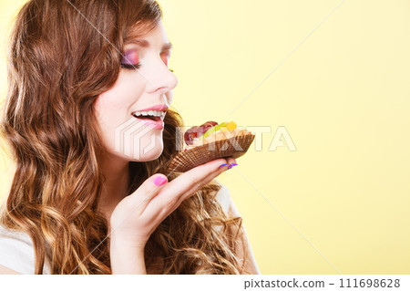 woman closed eyes holds cake in hand 111698628