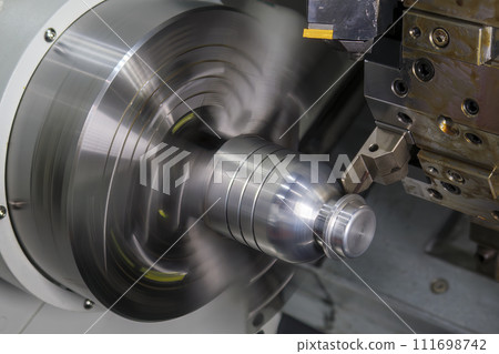 The  CNC lathe machine forming  cutting the metal shaft parts. 111698742