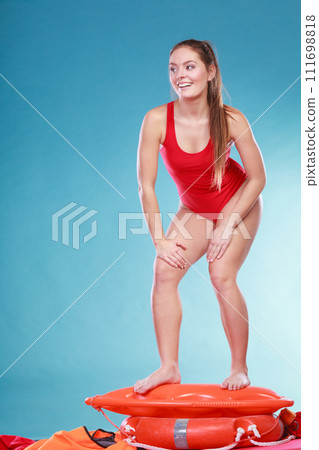 Happy lifeguard woman on rescue ring buoy. 111698818