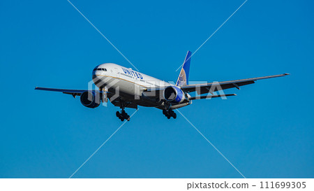 A passenger plane preparing to land at Narita Airport. 111699305
