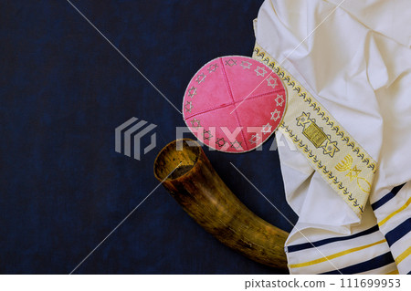 An Orthodox Jewish holiday symbol consists of prayer shawl tallit, head covering kippah, shofar An Orthodox Jewish holiday symbol consists of prayer shawl tallit, head covering kippah, shofar 111699953