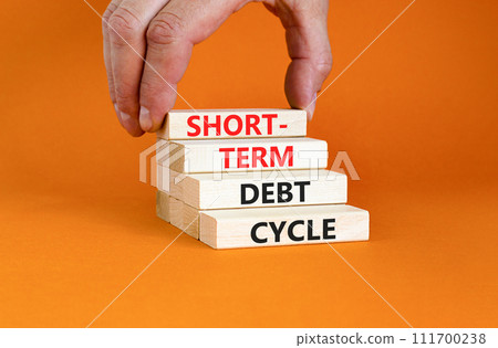 Short-term debt cycle symbol. Concept words Short-term debt cycle on beautiful wooden block. Beautiful orange table background. Businessman hand. Business Short-term debt cycle concept. Copy space. Short-term debt cycle symbol. Concept words Short-term debt cycle on beautiful wooden block. Beautiful orange table background. Businessman hand. Business Short-term debt cycle concept. Copy space. 111700238