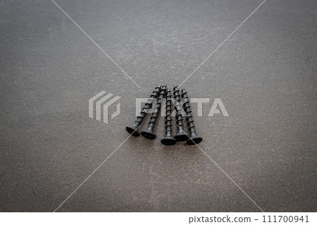 screws placed on a stainless steel plate screws placed on a stainless steel plate 111700941