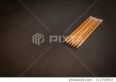 Pencils placed on a black top table Pencils placed on a black top table 111700952