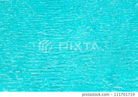 Ripple Water in swimming pool with blue tile floor background Ripple Water in swimming pool with blue tile floor background 111701719
