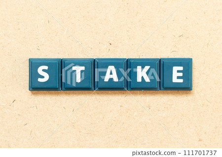 Tile alphabet letter in word stake on wood background Tile alphabet letter in word stake on wood background 111701737