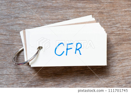 Flash card with handwriting in word CFR (abbreviation of Cost and freight) on wood background Flash card with handwriting in word CFR (abbreviation of Cost and freight) on wood background 111701745