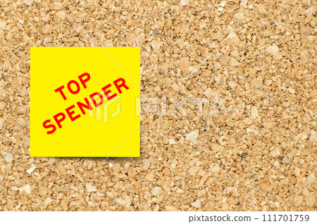 Yellow note paper with word top spender on cork board background with copy space Yellow note paper with word top spender on cork board background with copy space 111701759