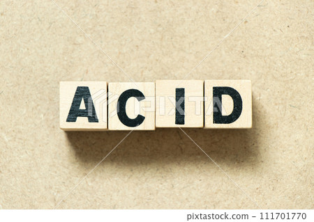 Alphabet letter block in word acid on wood background Alphabet letter block in word acid on wood background 111701770