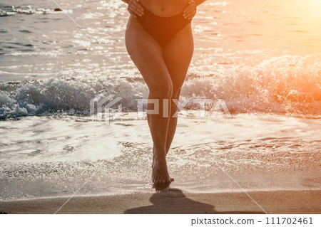 Woman summer travel sea. Happy woman enjoying her summer travels, captured in a lower body portrait, taking photos to preserve her memories of the scenic sea beach sharing travel adventure journey 111702461