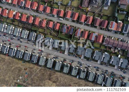 Aerial view of European real estate neighborhood, residential area housing estate, urban environment, city houses from above Aerial view of European real estate neighborhood, residential area housing estate, urban environment, city houses from above 111702509