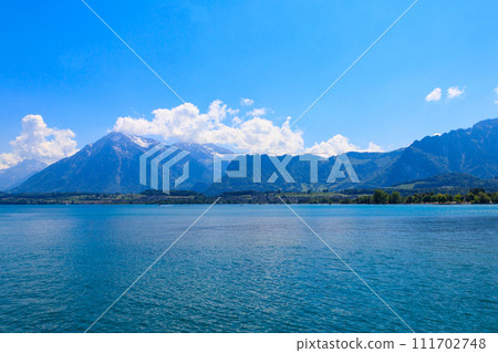 View of the Annecy lake surrounded by beautiful mountains in Annecy, France 111702748