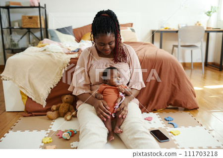 Happy mother playing with her child at home in bedroom Happy mother playing with her child at home in bedroom 111703218