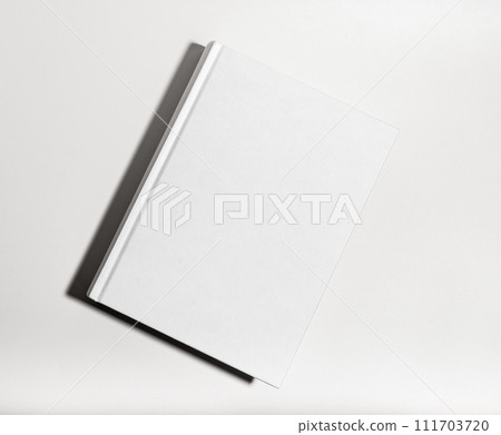 Blank book cover mockup. Clear textbook hardback, catalog lying on table Blank book cover mockup. Clear textbook hardback, catalog lying on table 111703720