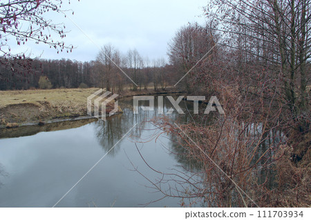 Landscape with river in autumn. Trees are reflected in water of river 111703934
