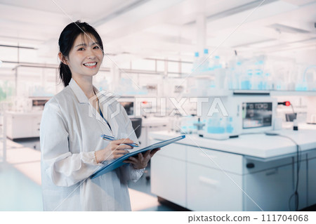 Female university student conducting experiments in the laboratory Female university student conducting experiments in the laboratory 111704068