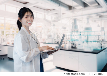 Female university student conducting experiments in the laboratory Female university student conducting experiments in the laboratory 111704069