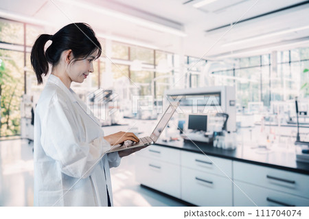 Female university student conducting experiments in the laboratory Female university student conducting experiments in the laboratory 111704074