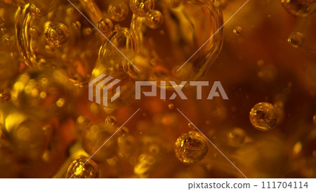 Freeze Motion Shot of Whiskey Liquid Pouring, Macro, Unique Angle of View from the Bottom of the Glass 111704114