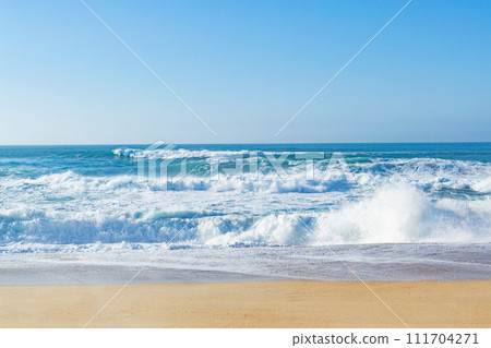 Beautiful ocean waves on a golden sand beach. Alone with nature. 111704271