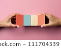 AI-generated content. Hand Holding Blank White Business Card on Pink Background 111704339