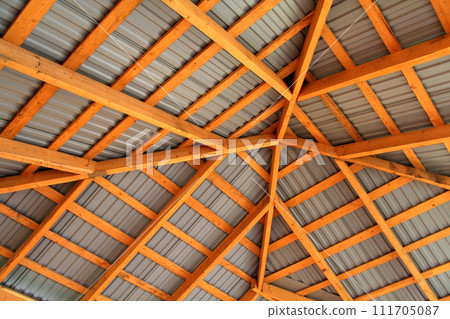 Wooden frame of new roof from inside. Construction framework. 111705087