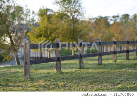 Wooden fence barrier at farm grounds for cattle and territory protection 111705090