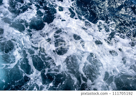 Top down aerial view of sea water surface. White foam waves texture as natural background. Top down aerial view of sea water surface. White foam waves texture as natural background. 111705192