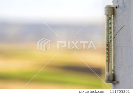 Thermometer celsius showing cold temperature on blurred background. Weather forecast concept. 111705201