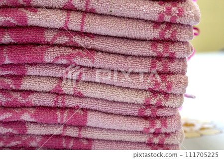 Stack of pink bath towels close-up with blurred background 111705225
