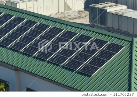 Residential apartment building with rooftop covered with solar photovoltaic panels for producing of clean ecological electrical energy. Concept of autonomous housing 111705287