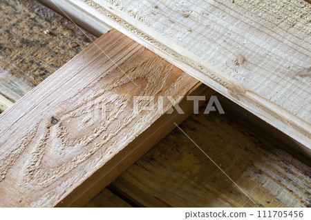 Installation of new floor of wooden natural planks and mineral wool insulation for isolation and keeping warmth. Construction, renovation, warm comfortable house concept. Installation of new floor of wooden natural planks and mineral wool insulation for isolation and keeping warmth. Construction, renovation, warm comfortable house concept. 111705456