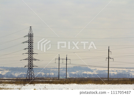 High power powerline poles with high voltage cables through the field High power powerline poles with high voltage cables through the field 111705487